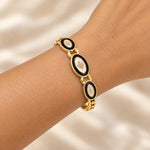 Noor Black Enamel Gold Bangle worn on wrist