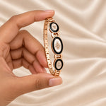 Noor Black Enamel Rose Gold Bangle square presented in hand
