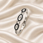 Noor Black Enamel Silver Bangle flatlay
