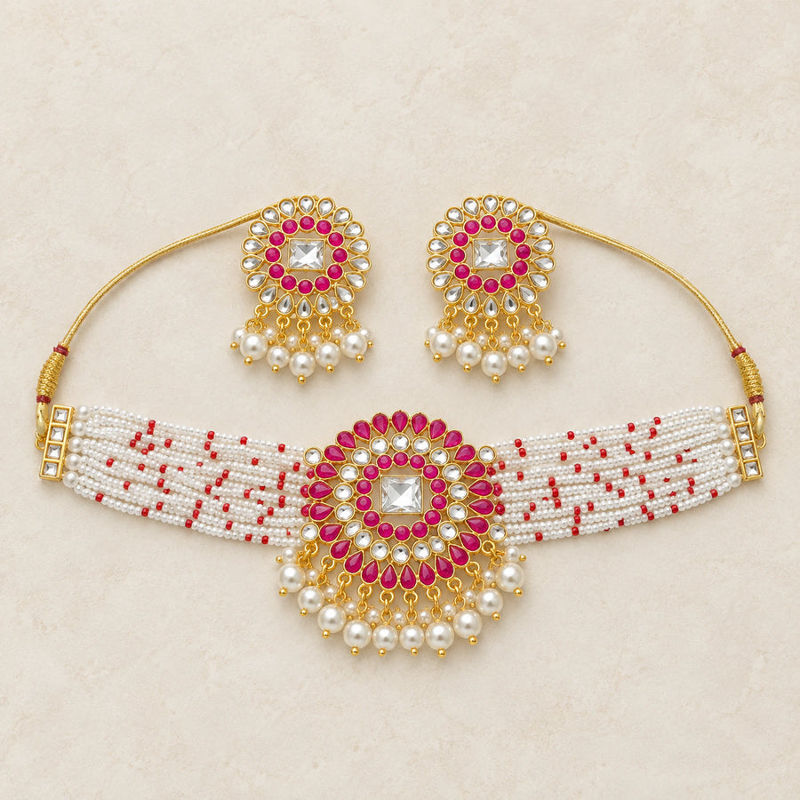 Magenta kundan pearl choker necklace and earrings set flatlay hero