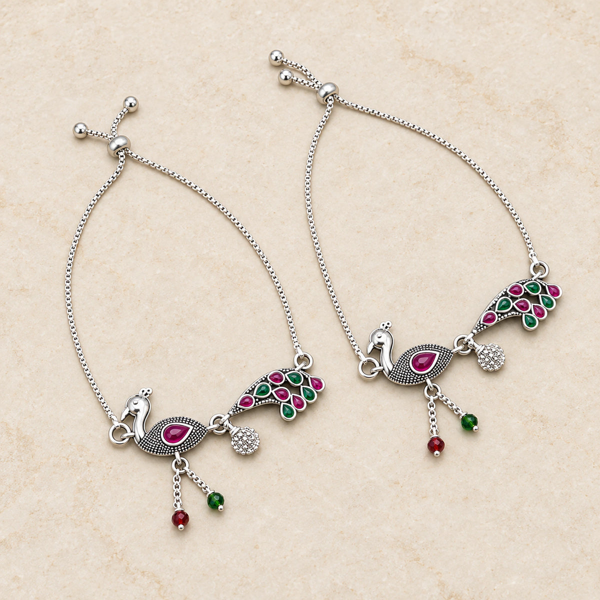 Oxidized silver peacock payal anklet pair flatlay hero view