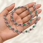 Rangoli Ruby Emerald Silver Payal Pair — hand presentation